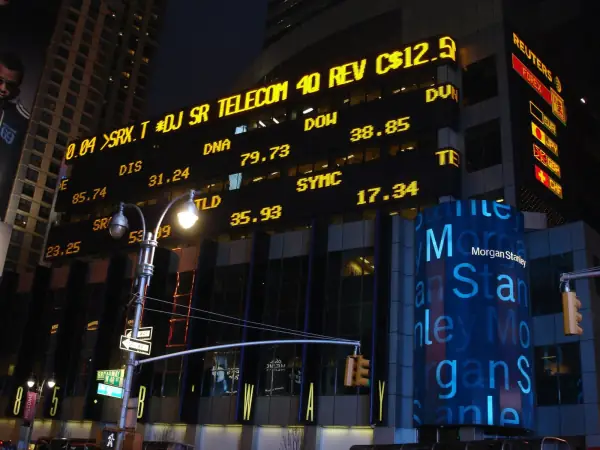 Morgan Stanley building in Times Square at night with stock ticker displays