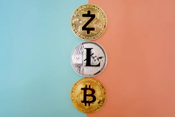 Zcash, Litecoin and Bitcoin coins on a colorful gradient background