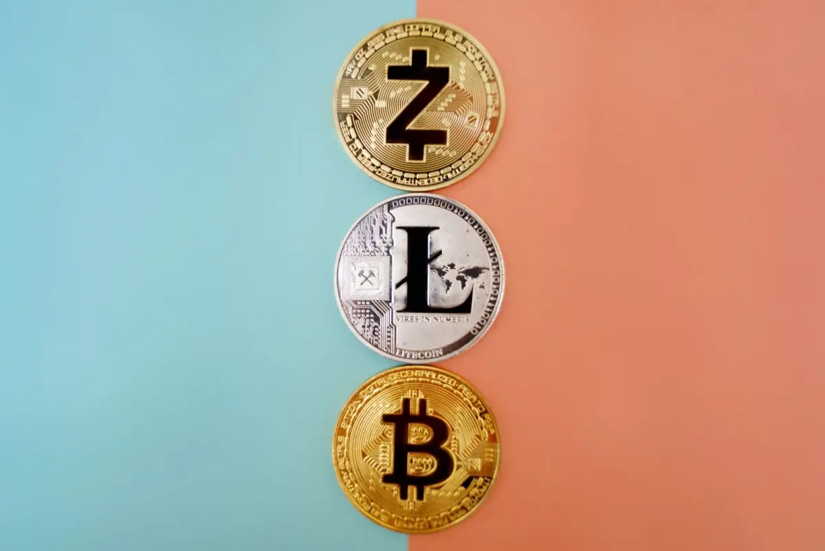 Zcash, Litecoin and Bitcoin coins on a colorful gradient background
