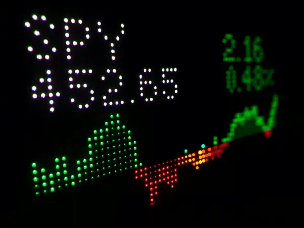 Digital stock ticker display showing an index fund price with a trend line
