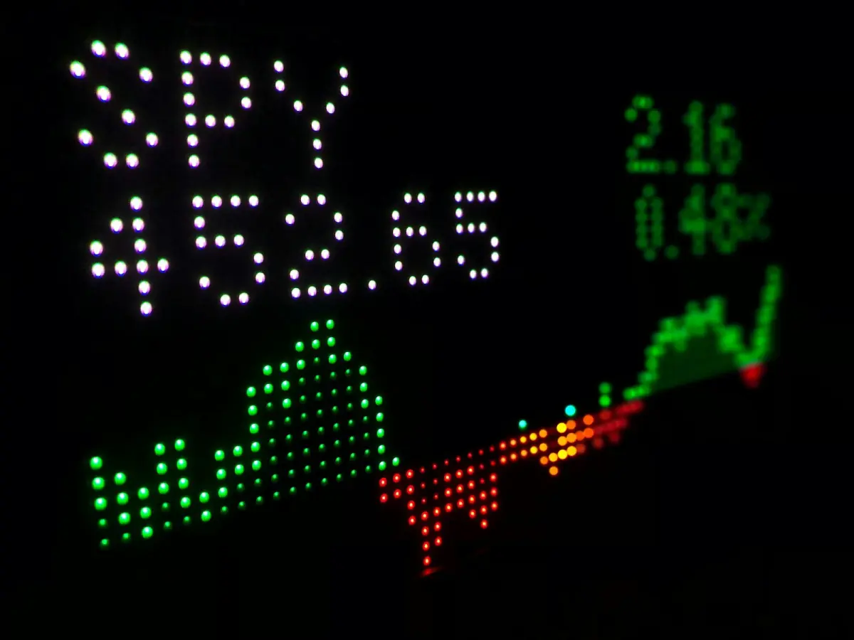 Digital stock ticker display showing an index fund price with a trend line